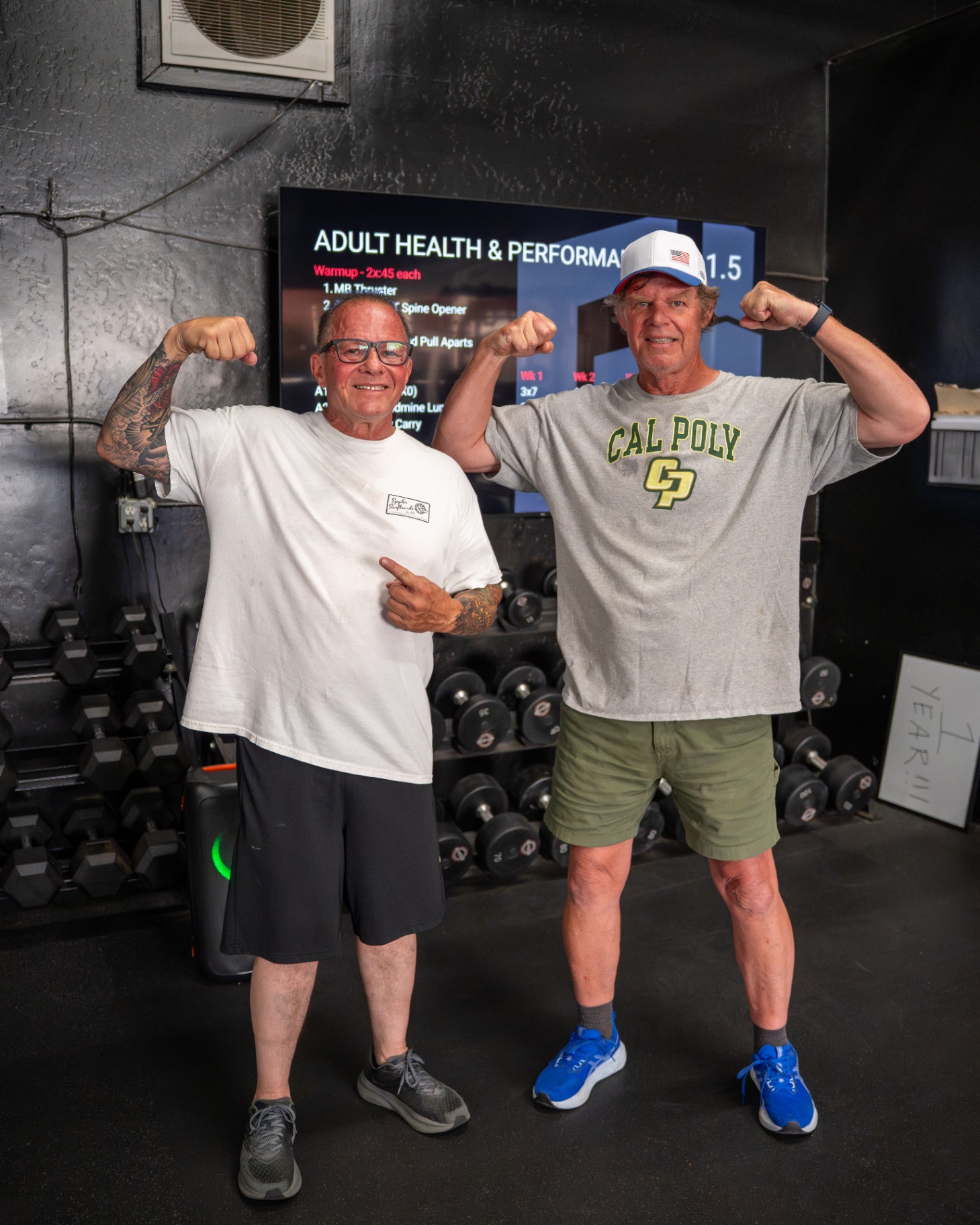 Two Grindhäus clients flexing after training
